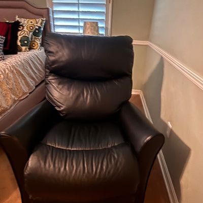 Sale Photo Thumbnail #54: Black leather overstuffed recliner with plush pillow-top cushioning and rolled armrests, placed in a bedroom setting.