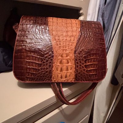 Sale Photo Thumbnail #58: Vintage two-tone alligator or crocodile skin handbag with shoulder strap, displayed on a shelf.