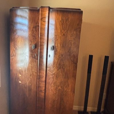 Sale Photo Thumbnail #83: Art Deco walnut veneer two-door wardrobe armoire featuring book-matched burl wood grain and decorative metal handles.