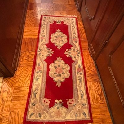 Sale Photo Thumbnail #114: Hand-tufted Chinese Peking style runner rug featuring a rich red field with floral medallions and a fringed edge.