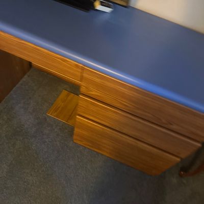 Sale Photo Thumbnail #46: Modern wooden desk featuring a blue laminate top and three storage drawers.