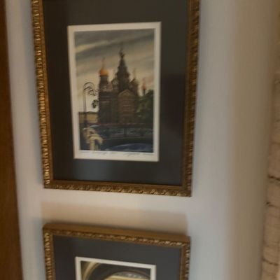 Sale Photo Thumbnail #181: Pair of framed architectural prints featuring Russian landmarks, set in ornate gilded frames with dark mats.