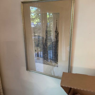 Sale Photo Thumbnail #197: Framed vintage architectural etching depicting a European cityscape with church towers, presented under glass in a silver-toned metallic frame with wide matting.