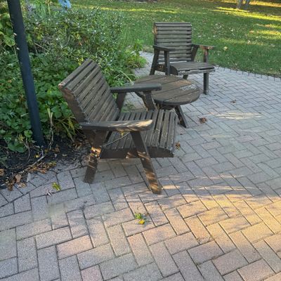 Sale Photo Thumbnail #138: Set of dark brown wooden slat patio furniture, including two armchairs and a small round accent table, showing light weather wear.