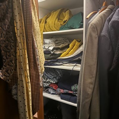 Sale Photo Thumbnail #24: Closet filled with men's clothing, featuring hanging neckties, jackets, and folded shirts and linens on built-in shelving.
