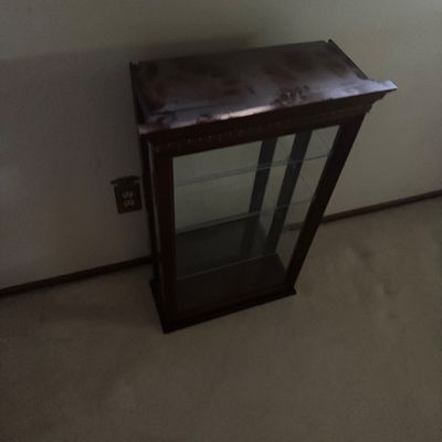 Sale Photo Thumbnail #37: Small dark wood curios display cabinet featuring glass-paneled sides and two interior glass shelves.