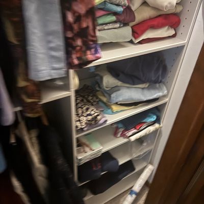 Sale Photo Thumbnail #16: Closet shelves filled with folded t-shirts, tops, and assorted casual clothing.