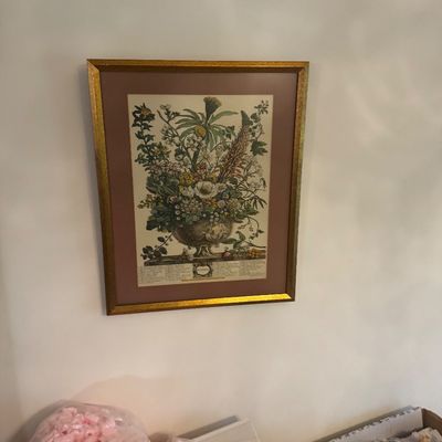 Sale Photo Thumbnail #212: Framed botanical floral print featuring an arrangement of flowers in a classical urn, set in a gold metallic frame with a muted brown mat.