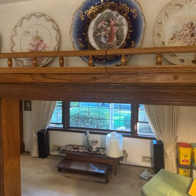Sale Photo Thumbnail #203: Collection of ornate decorative porcelain plates displayed on a wooden shelf above a room divider.
