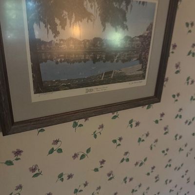 Sale Photo Thumbnail #30: Framed landscape art print featuring a lake scene with trees and houses, set in a dark wood frame with a wide grey mat.