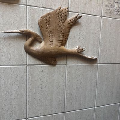 Sale Photo Thumbnail #43: Hand-carved wooden wall plaque depicting a crane in flight mounted on tile.