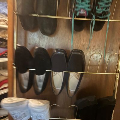 Sale Photo Thumbnail #21: A brass-tone over-the-door shoe rack holding various pairs of men's and women's shoes, including sneakers and dress shoes.