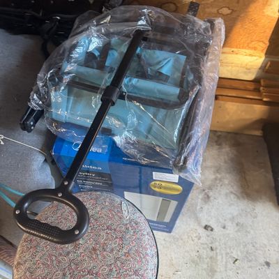 Sale Photo Thumbnail #88: Foldable utility wagon wrapped in plastic resting on a boxed Midea dehumidifier alongside a paisley padded stool.