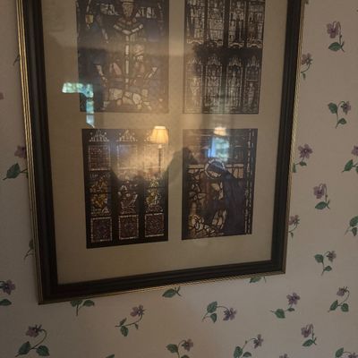 Sale Photo Thumbnail #29: Framed wall art featuring four prints of stained glass panels with religious imagery, housed in a black frame with gold trim.
