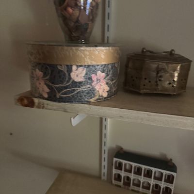 Sale Photo Thumbnail #71: Assorted home decorative items displayed on wall-mounted shelves, including a round floral fabric box topped with a vase of potpourri, an ornate brass jewelry box, and a miniature architectural building accent.