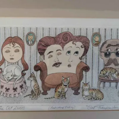 Sale Photo Thumbnail #6: Framed hand-colored etching titled "The Cat Lovers" by Curt Frankenstein, numbered 17/100, featuring surrealist illustrations of anthropomorphic furniture and cats.