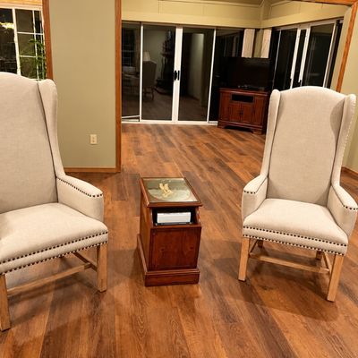 White wingback chairs with nailhead trim
