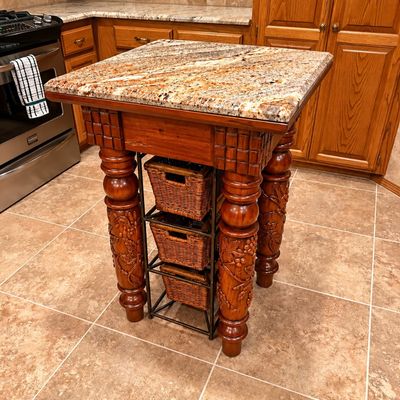 Kitchen island with marble top and ornate legs