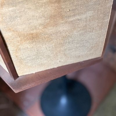 Vintage floor lamp featuring a wooden shade frame with original fabric panels mounted on a black pedestal base.