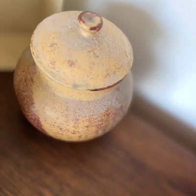 Sale Photo Thumbnail #123: Small, dusty stoneware lidded jar featuring a textured, rustic finish and a rounded knob handle.
