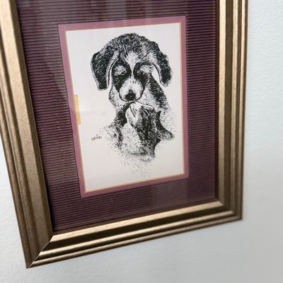 Sale Photo Thumbnail #155: Framed black-and-white print of a dog and a cat, double-matted in burgundy and gold-toned wood frame.