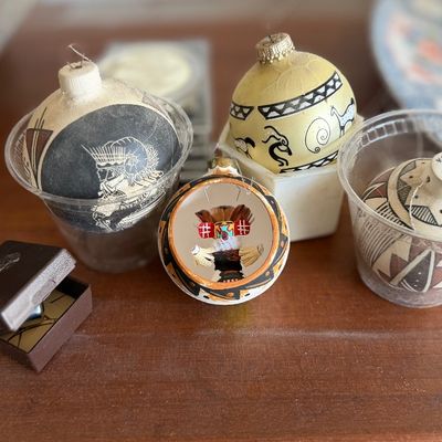 Collection of hand-painted Southwest and Native American style Christmas ornaments featuring geometric patterns and kachina figures.