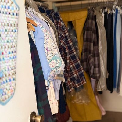 Sale Photo Thumbnail #154: Closet filled with assorted vintage clothing, including plaid shirts, jackets, trousers, and hanging garment bags.