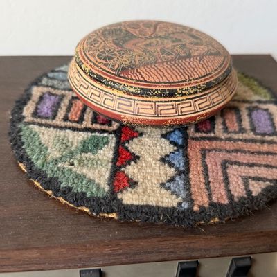 Small vintage round decorative container with Greek key and pictorial motifs.