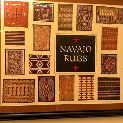 Framed Navajo Rugs chart poster in a dark wood frame.