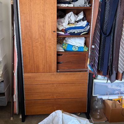 Sale Photo Thumbnail #162: Mid-century modern teak armoire featuring upper cabinet shelves, built-in tie racks, interior drawers, and lower storage drawers.