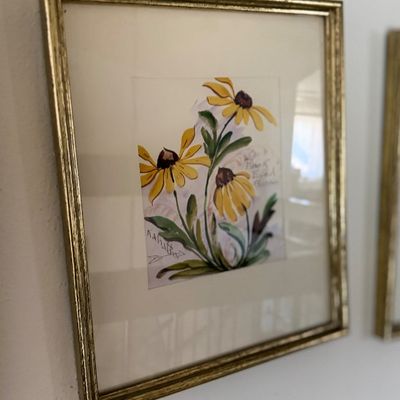 Sale Photo Thumbnail #101: Framed floral watercolor painting depicting yellow coneflowers in a thin gold frame.