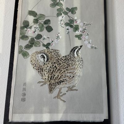 Framed Japanese woodblock print depicting quail beneath flowering branches.