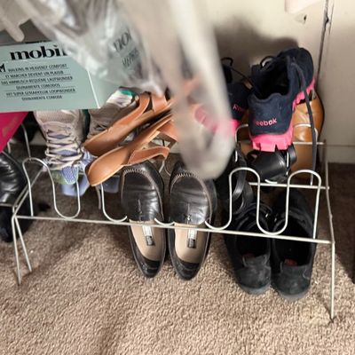 Sale Photo Thumbnail #158: Collection of men's and women's footwear on metal shoe racks alongside various original shoe boxes.