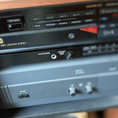 Vintage stereo components including a black Sony 5-disc automatic CD player changer sitting above a grey NAD 2400 Power Envelope stereo...