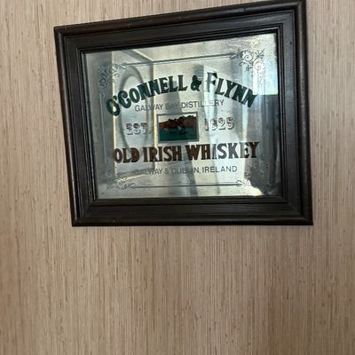 Framed O'Connell & Flynn Old Irish Whiskey pub mirror in a dark wood frame.