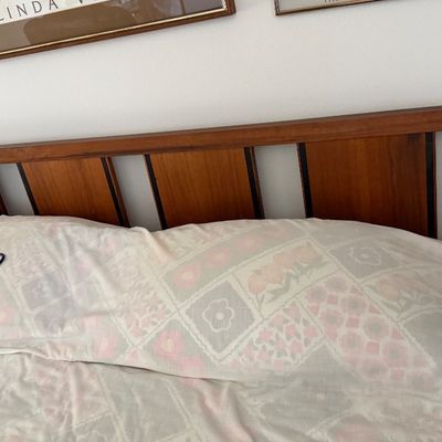 Sale Photo Thumbnail #161: Mid-century modern wooden headboard attached to a bed frame.