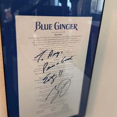 Framed, autographed restaurant menu from Blue Ginger, dated June 2008, featuring a dark blue mat and simple metallic frame.