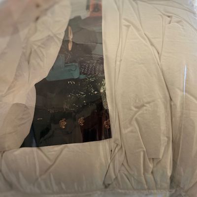 Bedding set in original plastic packaging.