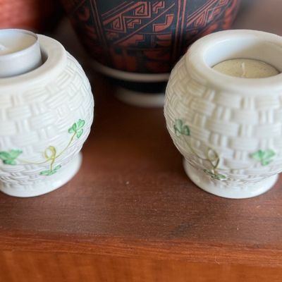 Pair of Belleek Irish porcelain votive tea light holders featuring a basketweave texture and hand-painted shamrock accents.
