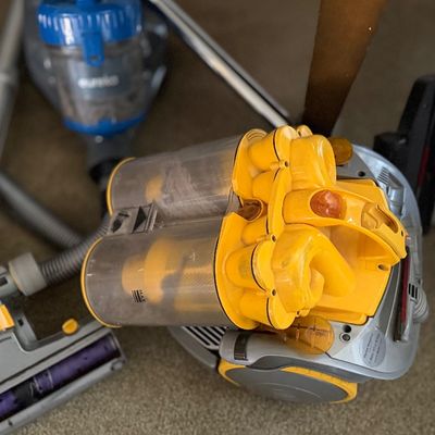 Yellow and grey Dyson canister vacuum cleaner.