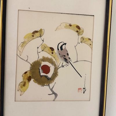 Framed Asian watercolor painting depicting a bird perched on a branch with leaves and a chestnut, featuring an artist signature stamp in...
