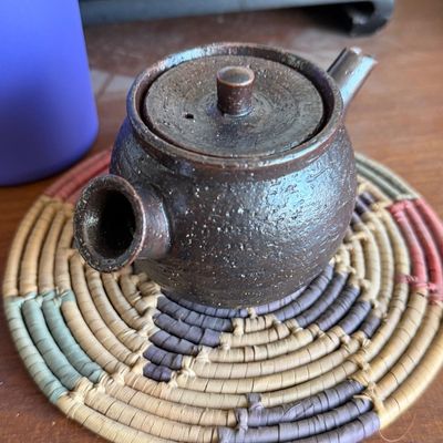 Japanese ceramic side-handled teapot (kyusu) with a textured dark stoneware finish.