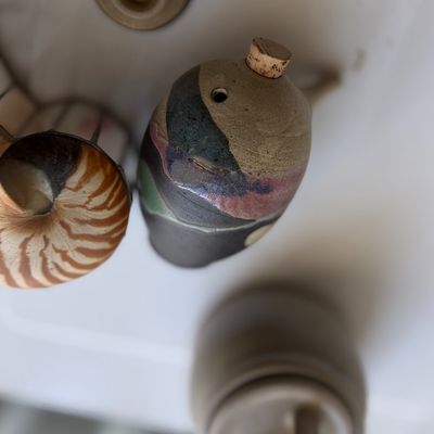 Handmade studio pottery teapot with cork stopper, featuring abstract glaze patterns.