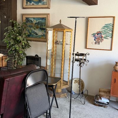 Sale Photo Thumbnail #180: Tall vintage hexagonal glass display cabinet with brass-toned frame and interior glass shelves.
