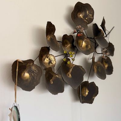 Sale Photo Thumbnail #143: Mid-century modern metal floral wall sculpture with gilded leaves and colorful glass bead accents.