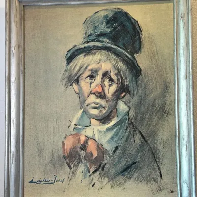 Sale Photo Thumbnail #155: Framed sad clown portrait print signed Leighton-Jones, housed in a painted wooden frame.