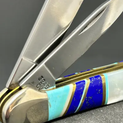 Sale Photo Thumbnail #181: Case pocket knife with a custom inlay handle featuring lapis, turquoise, and mother of pearl, stamped 3249 CV on the blade tang.