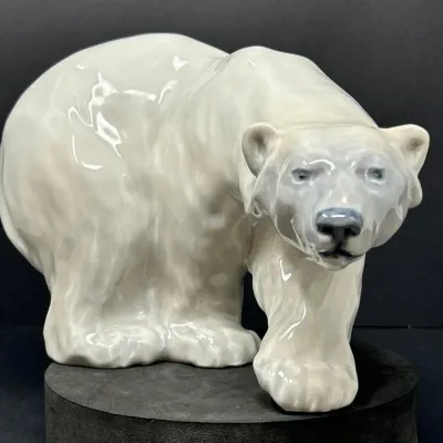 Sale Photo Thumbnail #58: Glazed porcelain polar bear figurine, featuring hand-painted details and a smooth finish, shown in good condition.