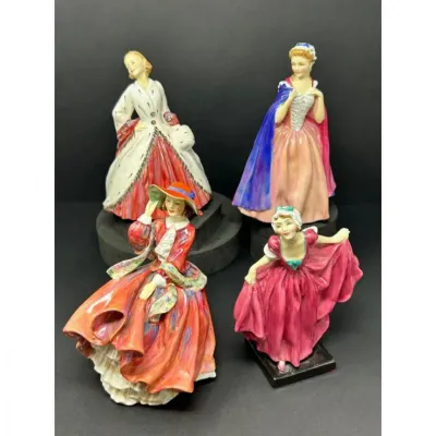 Sale Photo Thumbnail #165: Collection of four vintage hand-painted porcelain lady figurines in colorful period dresses, featuring detailed gowns and hats in good condition.