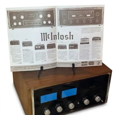 Sale Photo Thumbnail #2: Vintage McIntosh MC 2105 solid state power amplifier in a wooden cabinet, paired with an original promotional brochure.
